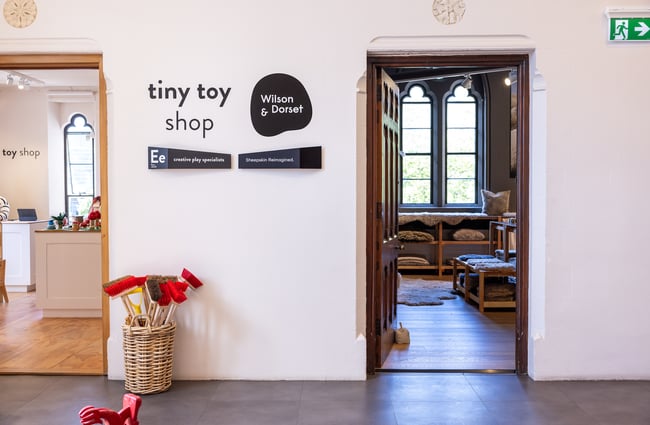 Signs for Tiny Toy Shop and Wilson & Dorset at The Arts Centre in Christchurch