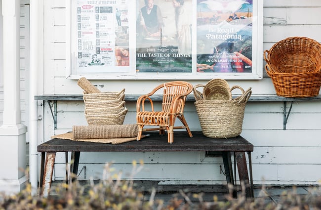 A little chair and baskets on display outside The Aviary Gisborne.