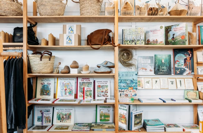 Works of art and greeting cards on display on shelves.