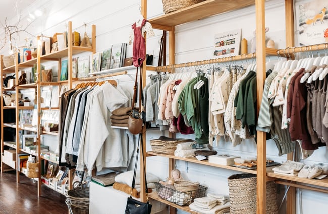 Baby clothings on racks inside The Aviary Gisborne.