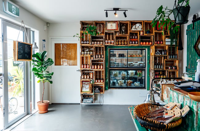 Wall of shelves and products in the bakery at The Baked Dane.