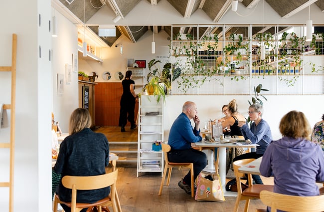 Customers sitting at tables in the cafe area at The Birdwood.