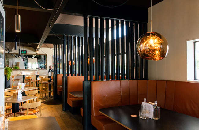 Table and booth seating in the restaurant section of The Birdwood.
