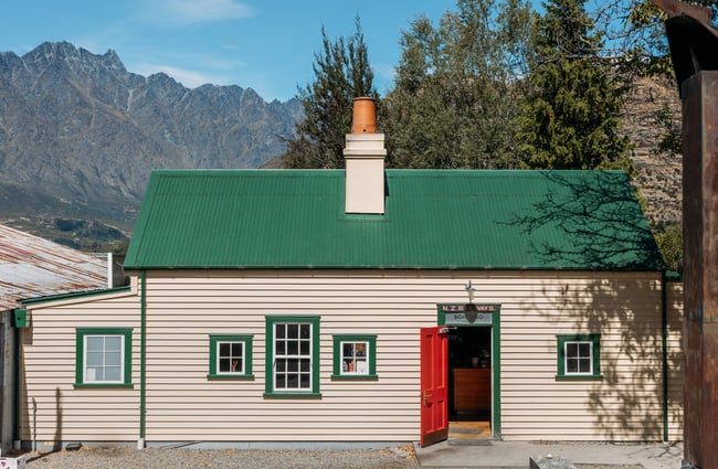 The cream, green and red exterior of Boat Shef cafe.