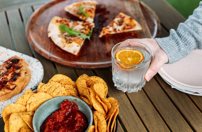 Table of food and a gin and tonic.