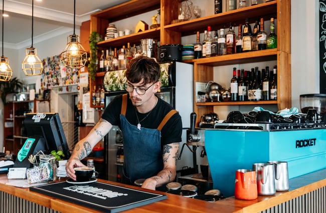 A man working behind a bar.