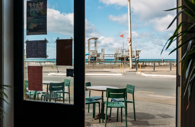A view of the ocean from inside a cafe.