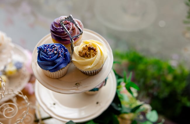 A close up of three cupcakes on a table.