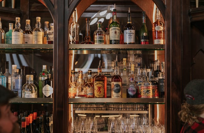 Liquor bottles behind glass cabinets.