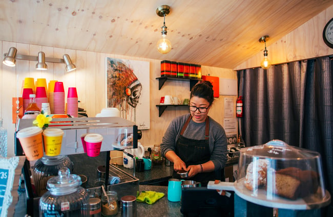 A barista making a coffee.
