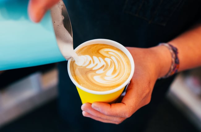 A coffee being poured into a cup.