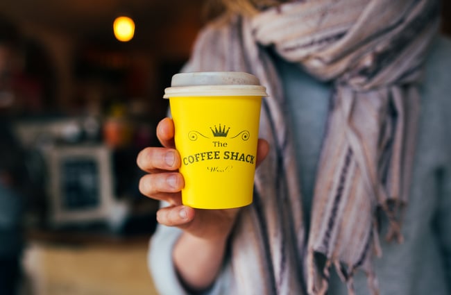 A customer holding a coffee cup.