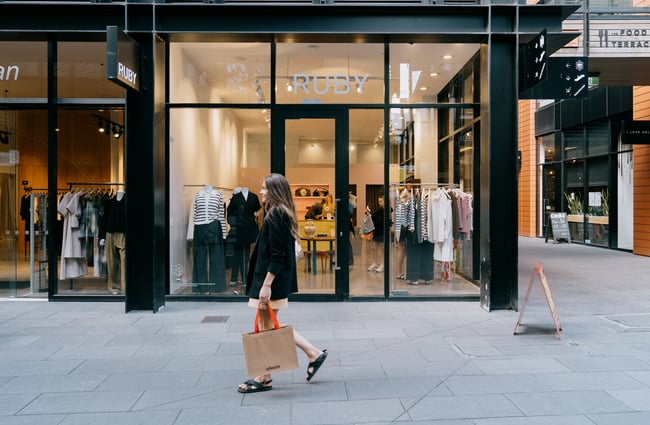 Person walking past Ruby store at The Crossing in Christchurch