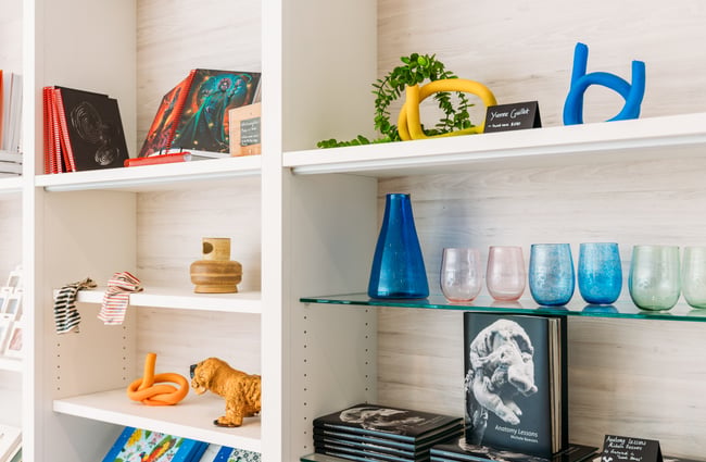Cups and vases on display in a gallery gift shop.