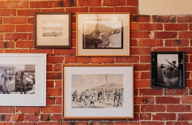 Old photographs on a brick wall.
