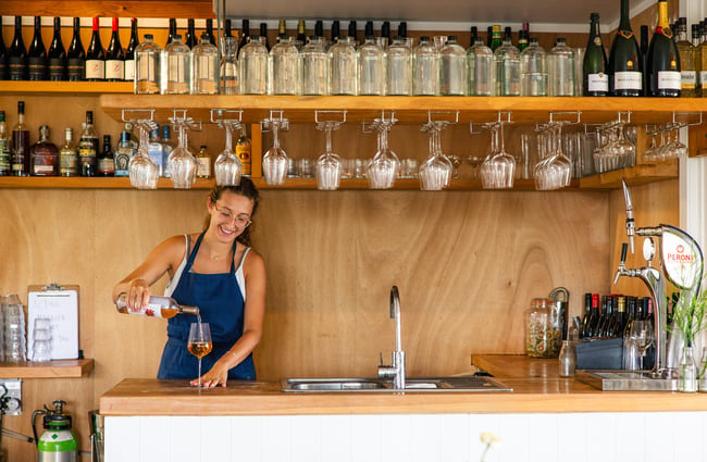 Bartender pouring a glass of wine at The Farmers Daughter.