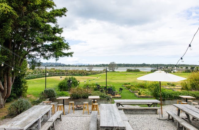 Outdoor seating and view of the water at The Farmers Daughter.