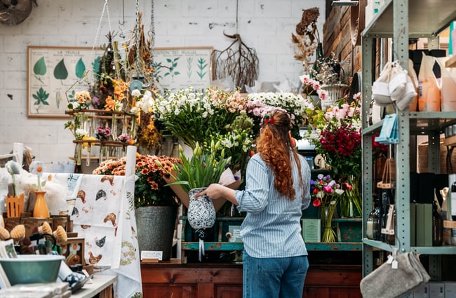 Shop assistant tending to some flowers and plants at The Flower Crate.