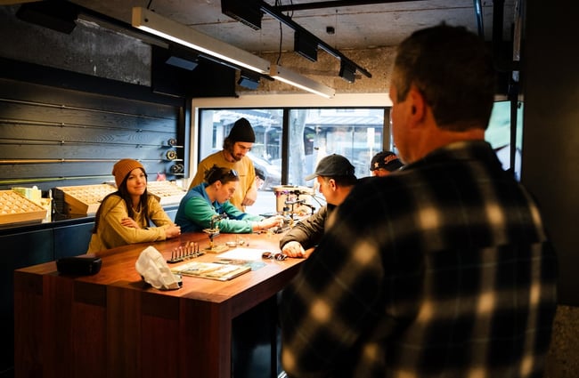A group of people making flys at Patagonia's Fly Bar in Queenstown.
