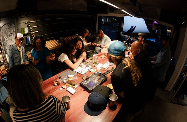 A group of people making flys at Patagonia's Fly Bar in Queenstown.