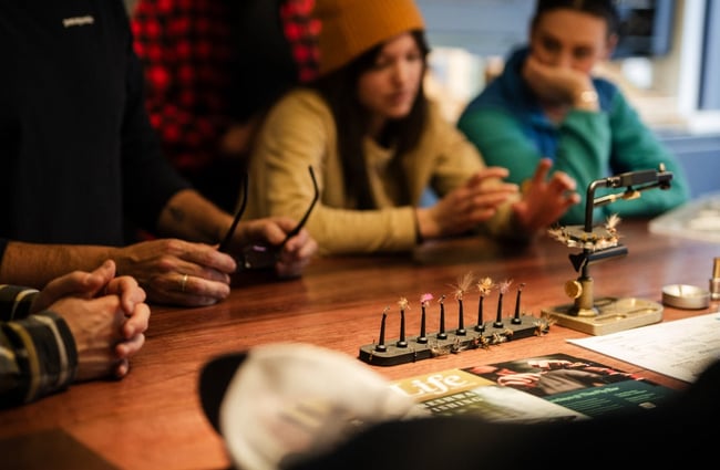 People at work around a table at Patagonia's Fly Bar in Queenstown.