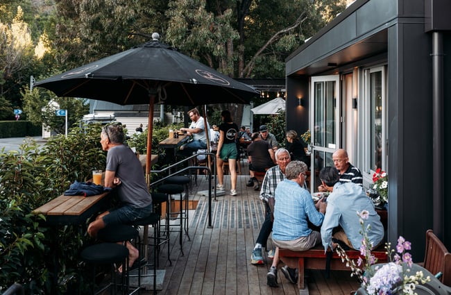 Customers dining outside on a verandah in Arrowtown.