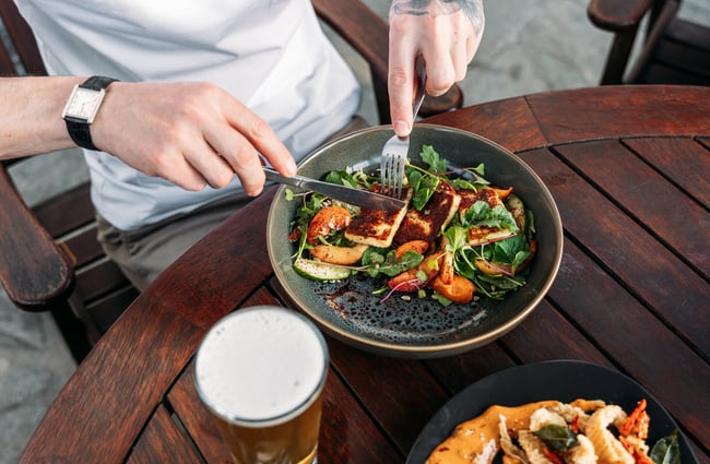 A person eating a salad.