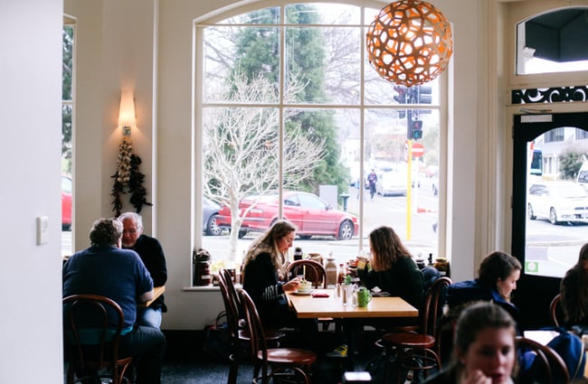 Customers dining in at tables by the window.