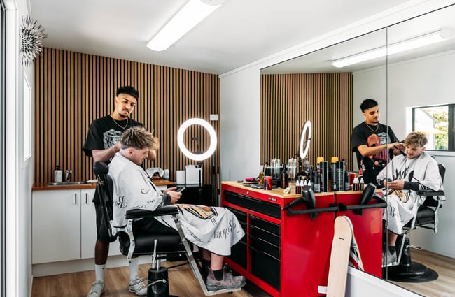 Customer in the barber's chair having their hair cut at The Green.