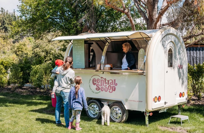 Customers standing in front of the real fruit ice cream truck at The Green.