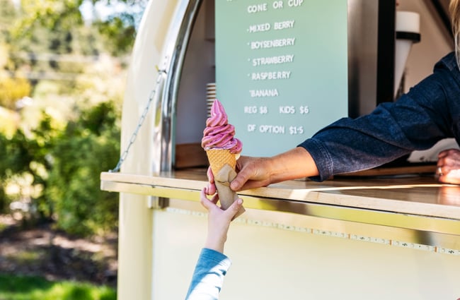 Real fruit icecream in a cone being handed to a customer at The Green.