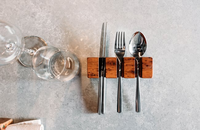 A close up of cutlery on a counter.