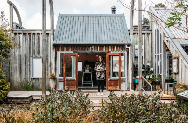 Woman standing on the verandah of the The Herb Farm.