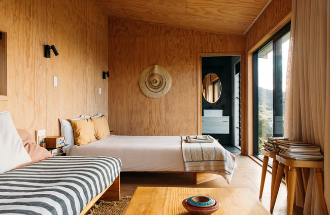 Bed and lounge area at The Huts.