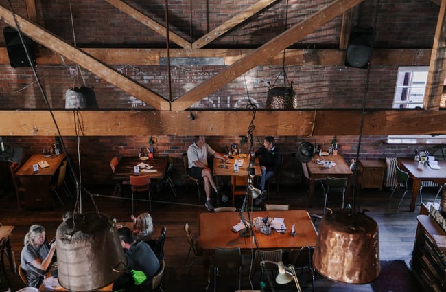 The indoor restaurant with diners.