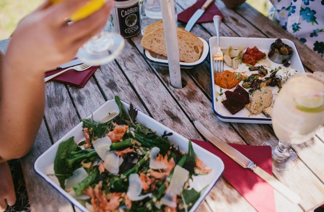 A table of food on an outside table.