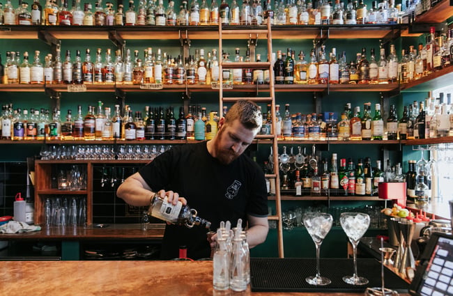 A barman making cocktails.