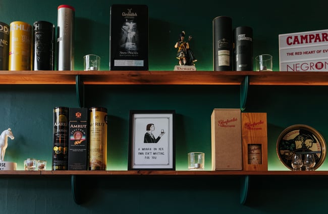 Close up of liquor bottles on shelves.