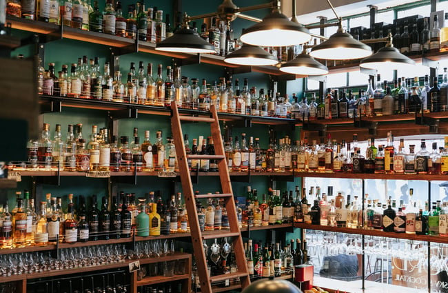 All the liquor bottles on display on shelves.