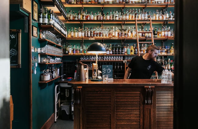 A barman working behind the counter.