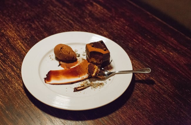 A chocolate dessert on a table inside The Library bar Wellington.