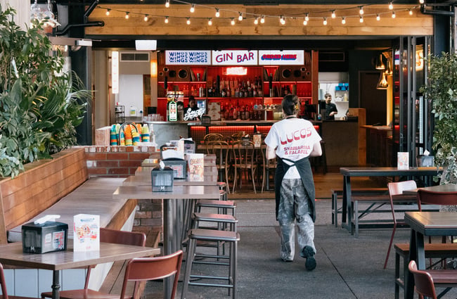 Lucas staff member walking into entrance of Little High Eatery in Christchurch