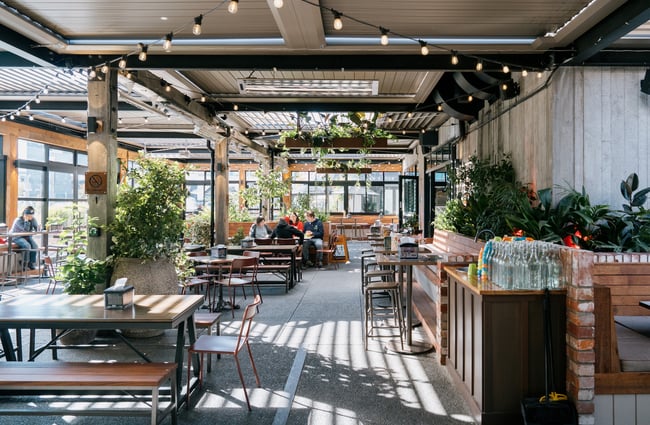 People dining in outdoor courtyard at Little High Eatery in Christchurch