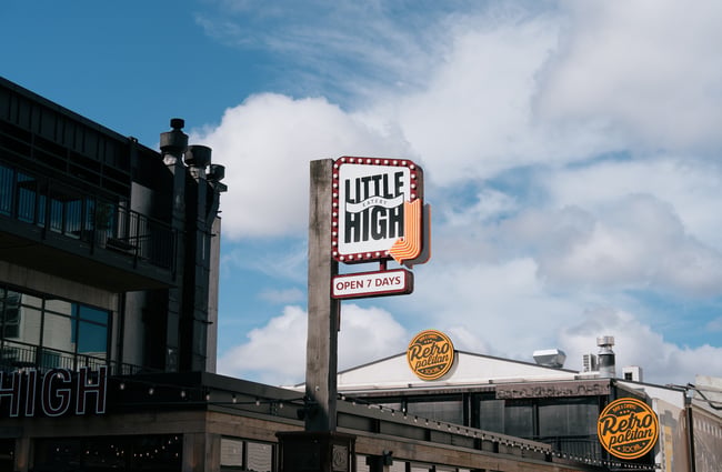 Little High Eatery sign against blue sky backdrop