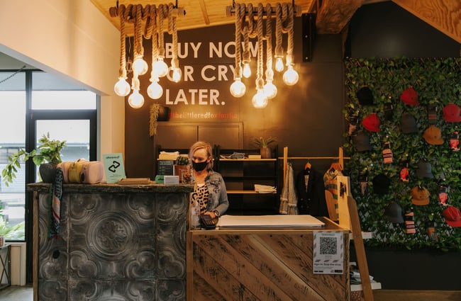 A staff member working behind the counter inside The Red Little Fox store in Fairlie.
