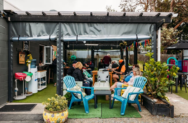 Customers dining in an outdoor seating area.