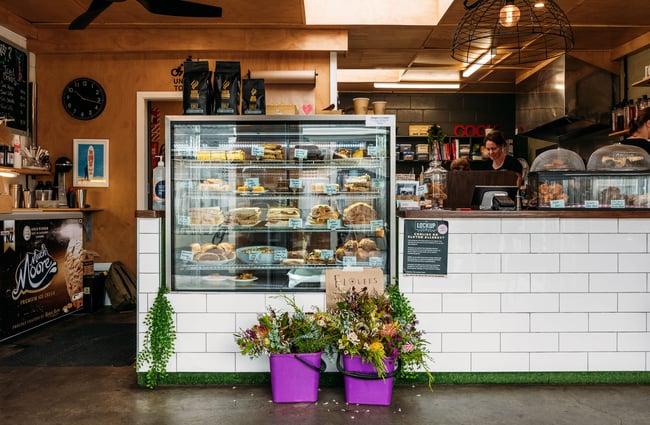 The counter and glass cabinet inside a cafe.