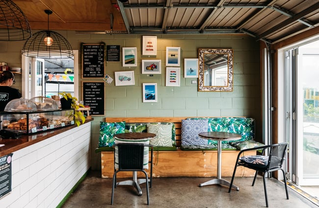 A bench seat with green cushions.