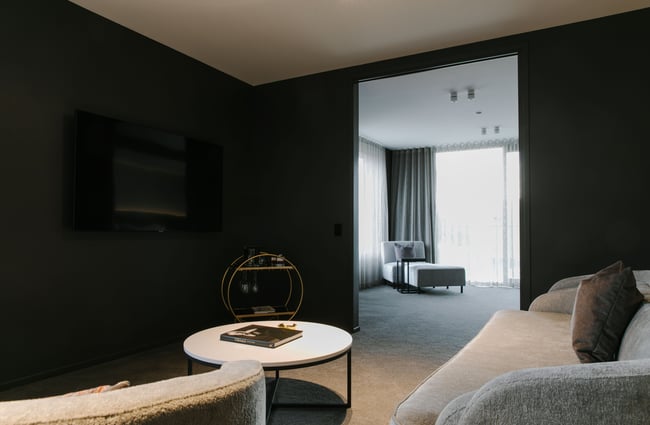 The moody lounge next to a bedroom inside a Mayfair Hotel suite.
