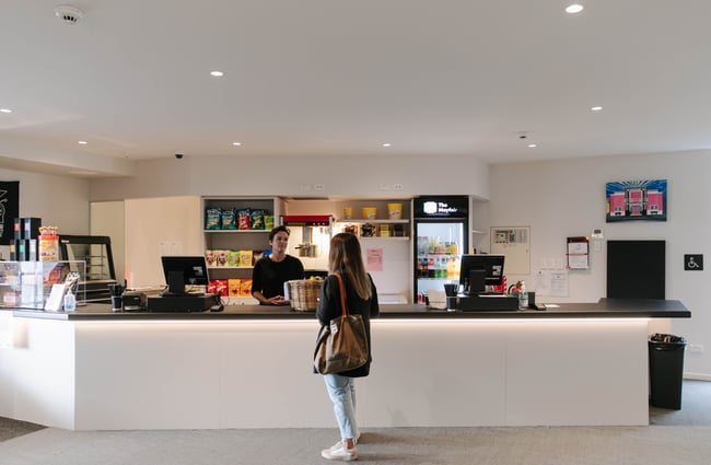 Woman ordering popcorn at the counter at The Mayfair.